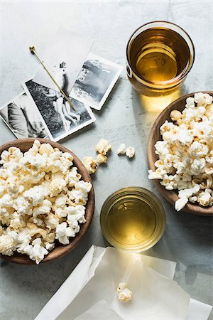 popcorn top view - Still life of popcorn and drink, beside old black and white photographs, overhead view Stock Photo - Premium Royalty-Free, Code: 649-08902157