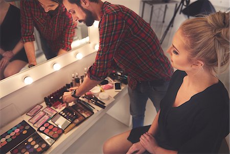 Male make up artist selecting make up for photo shoot Stock Photo - Premium Royalty-Free, Code: 649-08902236