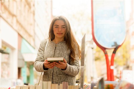 Portrait of young woman holding book at market stall Stockbilder - Premium RF Lizenzfrei, Bildnummer: 649-08924008