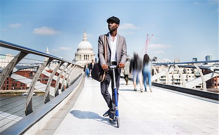 full body businessman outside - Businessman on scooter, Millennium Bridge, London, UK Stock Photo - Premium Royalty-Free, Code: 649-08924113