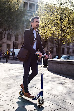 pictures of people riding scooters - Businessman on scooter, Trafalgar Square, London, UK Stock Photo - Premium Royalty-Free, Code: 649-08924134