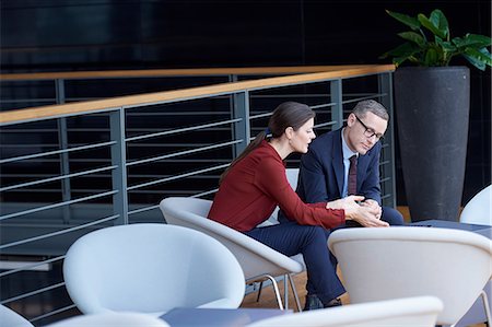 Businesswoman and man having meeting on office balcony Stock Photo - Premium Royalty-Free, Code: 649-08924369