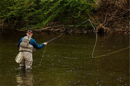 simsearch:649-08924660,k - Man fishing in river Foto de stock - Sin royalties Premium, Código: 649-08924658