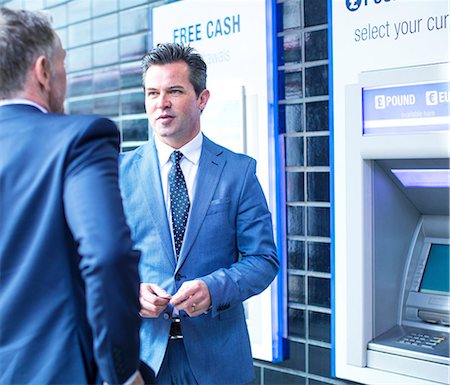 exterior of buildings - Businessmen talking by cash machine Stock Photo - Premium Royalty-Free, Code: 649-08924788