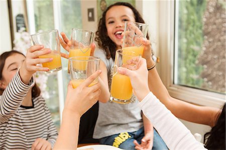 simsearch:649-08924834,k - Girls making a toast with fruit juice Photographie de stock - Premium Libres de Droits, Code: 649-08924841