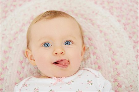 Portrait of baby girl lying on blanket, elevated view Stock Photo - Premium Royalty-Free, Code: 649-08922891