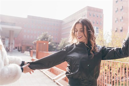 simsearch:649-08923050,k - Two young women, outdoors, dancing in street, smiling Stock Photo - Premium Royalty-Free, Code: 649-08923078