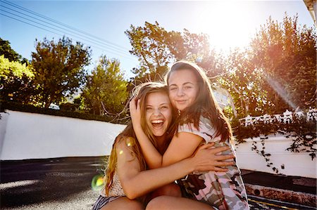 sisters sunlight - Teenage girls having fun in residential street, Cape Town, South Africa Stock Photo - Premium Royalty-Free, Code: 649-08923563