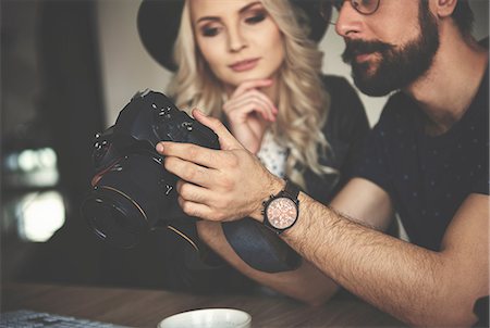 quality review - Photographers reviewing work on camera in photography studio Stock Photo - Premium Royalty-Free, Code: 649-08923680