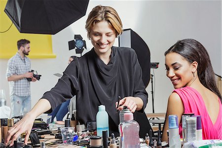 Fashion model and make up artist getting ready in photography studio Stock Photo - Premium Royalty-Free, Code: 649-08923857