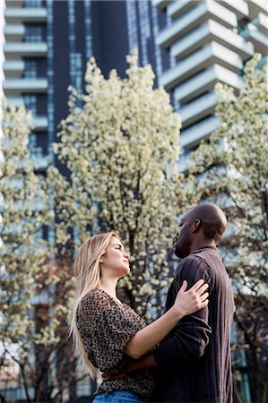 simsearch:649-08923913,k - Young couple hugging and gazing at each other in city Stock Photo - Premium Royalty-Free, Code: 649-08923906