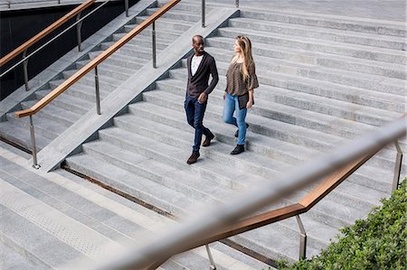 simsearch:649-08923913,k - Young businessman and woman moving down city stairway talking Stock Photo - Premium Royalty-Free, Code: 649-08923918