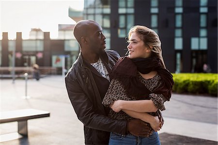 simsearch:649-08923913,k - Young couple in city hugging and gazing at each other Stock Photo - Premium Royalty-Free, Code: 649-08923926