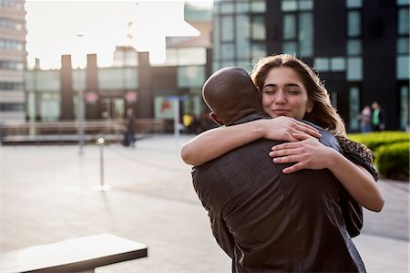 simsearch:649-08923926,k - Young couple in city hugging each other Foto de stock - Sin royalties Premium, Código: 649-08923928