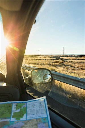 enroute - Wing mirror view of man with map on the road in sunlight, Arizona, USA Stock Photo - Premium Royalty-Free, Code: 649-08949329