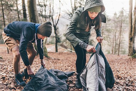 simsearch:649-08949532,k - Hiking couple packing sleeping bags in forest, Monte San Primo, Italy Stock Photo - Premium Royalty-Free, Code: 649-08949551