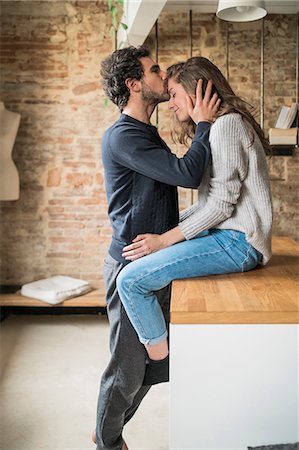simsearch:649-08949562,k - Young man kissing girlfriend on forehead at kitchen bench Foto de stock - Sin royalties Premium, Código: 649-08949574