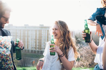 simsearch:649-08949687,k - Group of friends holding beer bottles,  enjoying roof party Stock Photo - Premium Royalty-Free, Code: 649-08949670