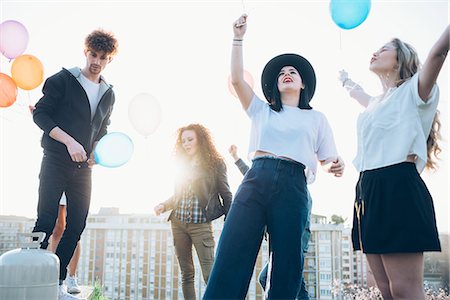 simsearch:649-08949687,k - Group of enjoying roof party, holding helium balloons Stock Photo - Premium Royalty-Free, Code: 649-08949682