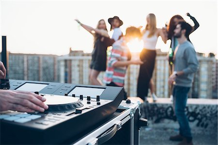 simsearch:649-08949687,k - Group of friends enjoying roof party, young man using mixing desk Stock Photo - Premium Royalty-Free, Code: 649-08949692