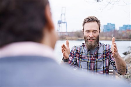 plaid shirt - Over shoulder view of male designers having discussion on waterfront outside design studio Stock Photo - Premium Royalty-Free, Code: 649-08949789