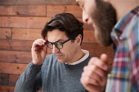 Male designers looking down in design studio meeting Stock Photo - Premium Royalty-Free, Code: 649-08949800