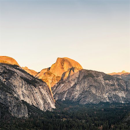 Elevated view of valley forest and mountains at sunset, Yosemite National Park, California, USA Stock Photo - Premium Royalty-Free, Code: 649-08950380