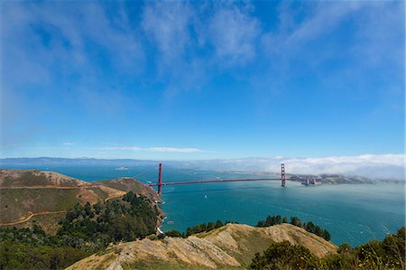 Fog blankets San Francisco, California, rolling into the city across San Francisco Bay, beyond Golden Gate Bridge Stock Photo - Premium Royalty-Free, Code: 649-08950391