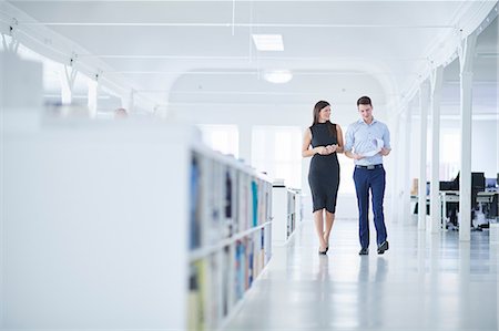 simsearch:649-08950473,k - Colleagues walking through office Stock Photo - Premium Royalty-Free, Code: 649-08950427