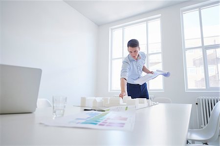 simsearch:649-09061548,k - Architect in office with blueprint looking at architectural model Stock Photo - Premium Royalty-Free, Code: 649-08950421
