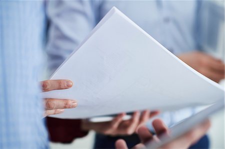 simsearch:649-08950473,k - Cropped view of colleagues holding paperwork Stock Photo - Premium Royalty-Free, Code: 649-08950471