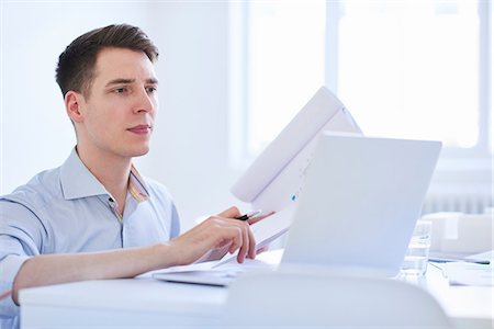 Man in office using digital tablet Stock Photo - Premium Royalty-Free, Code: 649-08950495