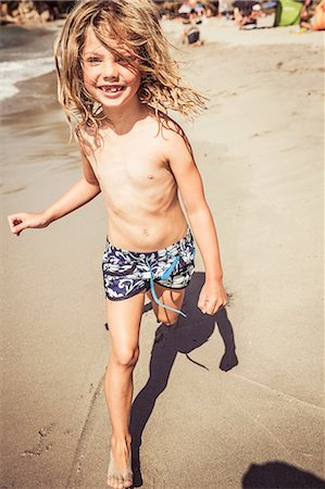 full length person is bathing suit - Young girl running on beach, smiling Stock Photo - Premium Royalty-Free, Code: 649-08950534