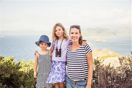 elementary age beach - Portrait of mother standing with two daughters, near sea, smiling Stock Photo - Premium Royalty-Free, Code: 649-08950532