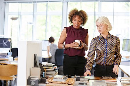 simsearch:649-08950791,k - Two female interior designers looking at swatches at office desk Stock Photo - Premium Royalty-Free, Code: 649-08950768