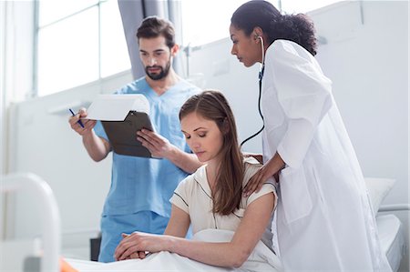 simsearch:649-08662036,k - Doctor examining patient with stethoscope Stock Photo - Premium Royalty-Free, Code: 649-08950881