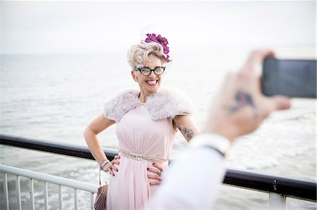 personalities - Man taking photograph of 1950's vintage style mature woman on pier on pier Stock Photo - Premium Royalty-Free, Code: 649-08951058