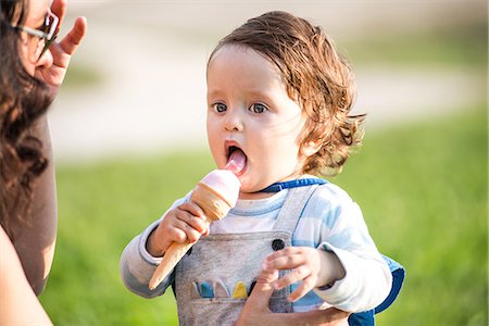 simsearch:649-09026311,k - Woman with toddler son eating ice cream cone in park Stock Photo - Premium Royalty-Free, Code: 649-08951068