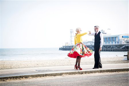 1950's vintage style couple holding hands and dancing on beach Stock Photo - Premium Royalty-Free, Code: 649-08951169