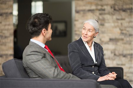 simsearch:6108-06167943,k - Businesswoman and man having meeting on office sofa Stock Photo - Premium Royalty-Free, Code: 649-08968802