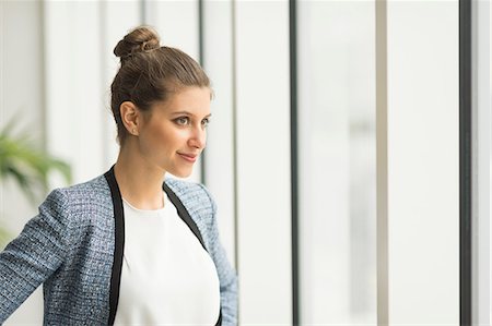 simsearch:649-09035446,k - Young confident businesswoman looking through office window Photographie de stock - Premium Libres de Droits, Code: 649-08968849