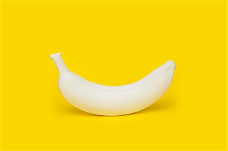 Banana painted white on yellow background Stock Photo - Premium Royalty-Free, Code: 649-08968874
