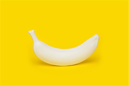 studio art - Banana painted white on yellow background Stock Photo - Premium Royalty-Free, Code: 649-08968874