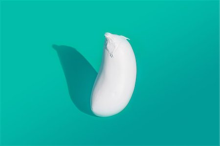 Aubergine painted white on turquoise background Stock Photo - Premium Royalty-Free, Code: 649-08968875