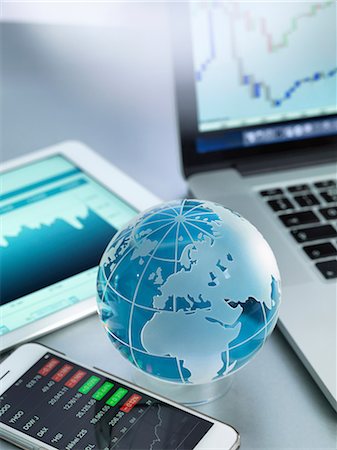 simsearch:614-08982748,k - Globe with smartphone, digital tablet and laptop showing international business graphs Stock Photo - Premium Royalty-Free, Code: 649-08968915