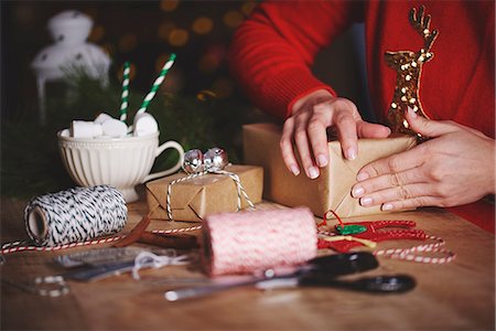 Woman wrapping christmas gift Stock Photo - Premium Royalty-Free, Code: 649-08969044