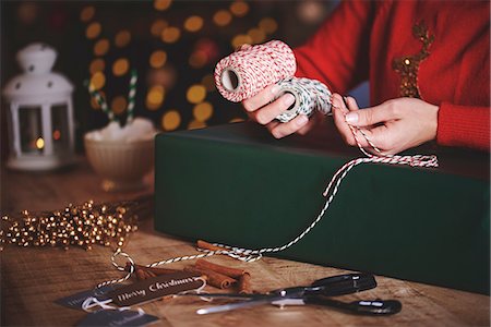 simsearch:649-08969050,k - Woman wrapping christmas gift with twine Stock Photo - Premium Royalty-Free, Code: 649-08969043