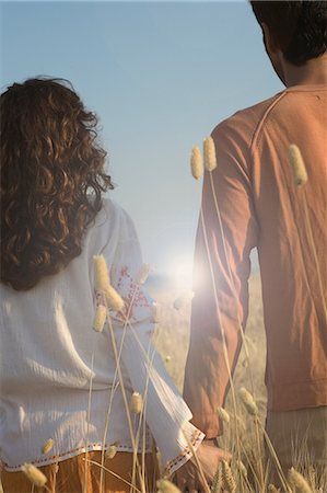 Rear view of couple holding hands in wheat field Stock Photo - Premium Royalty-Free, Code: 649-08969094