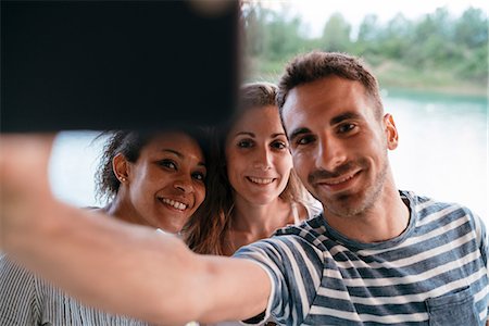 simsearch:649-09111243,k - Three friends outdoors, taking selfie with smartphone Photographie de stock - Premium Libres de Droits, Code: 649-08969338