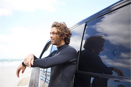 Kite surfer in wetsuit leaning against car, Hornbæk, Hovedstaden, Denmark Stock Photo - Premium Royalty-Free, Code: 649-08969372